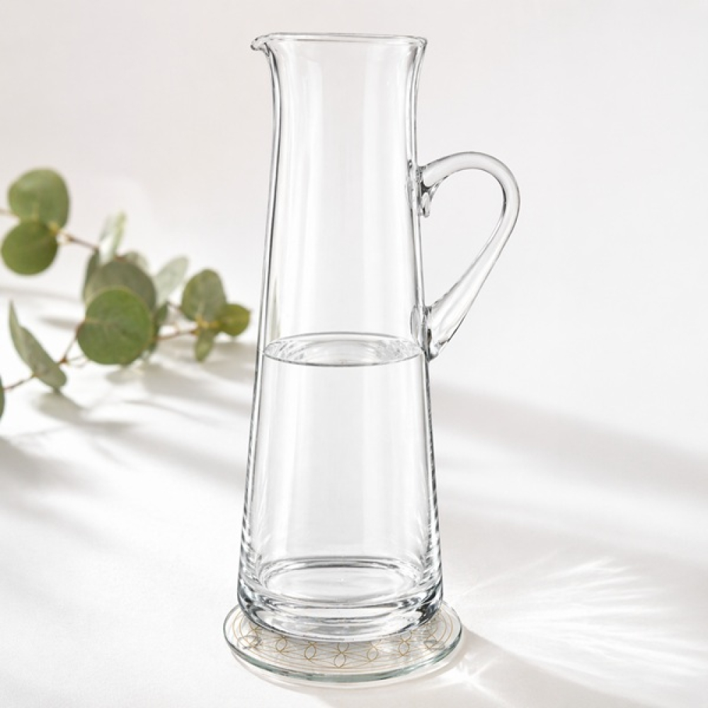 Kristallglasuntersetzer mit goldener Blume des Lebens Gravur mit Glaskaraffe in Anwendung